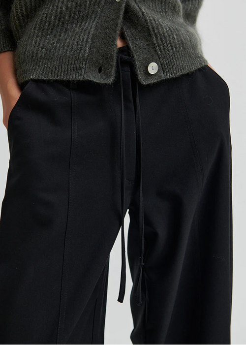Woman wearing black pants on a white background