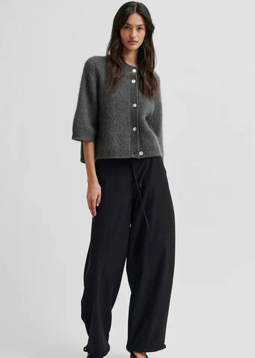 Woman wearing black pants on a white background