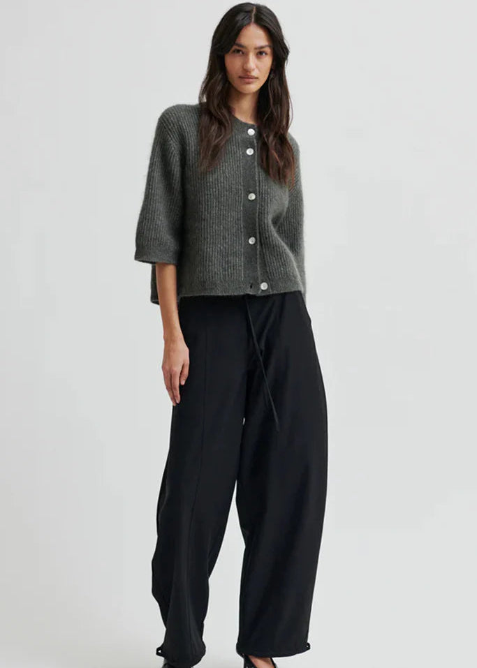Woman wearing black pants on a white background