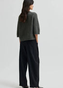 Woman wearing black pants on a white background
