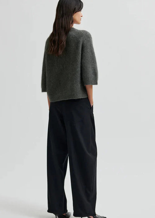 Woman wearing black pants on a white background