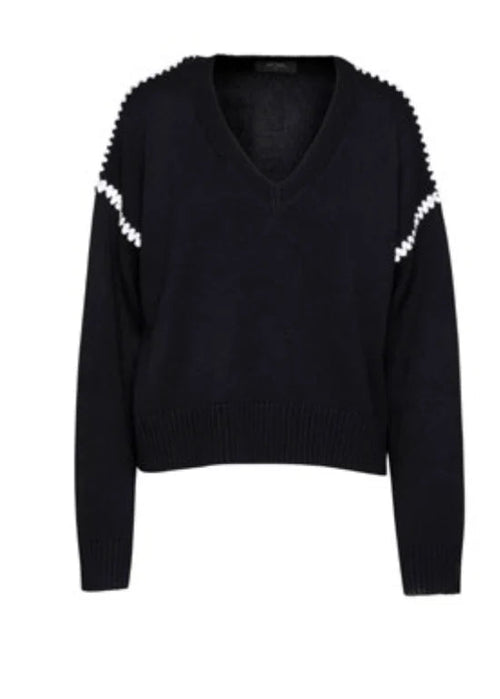 Black sweater with white embellishments on a white background
