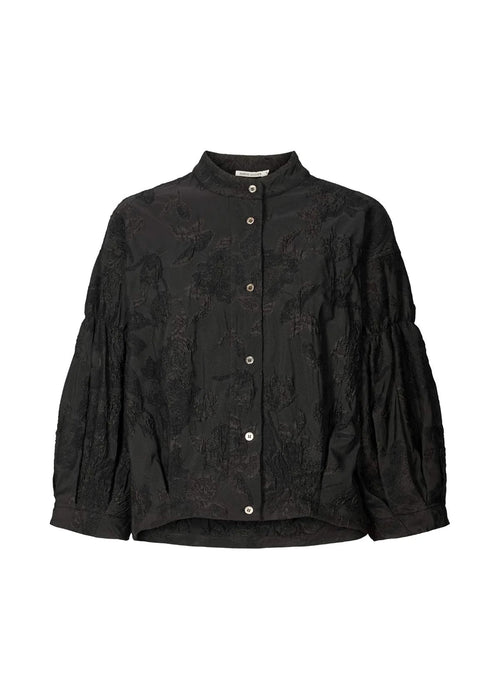 Black textured blouse with button details on a white background