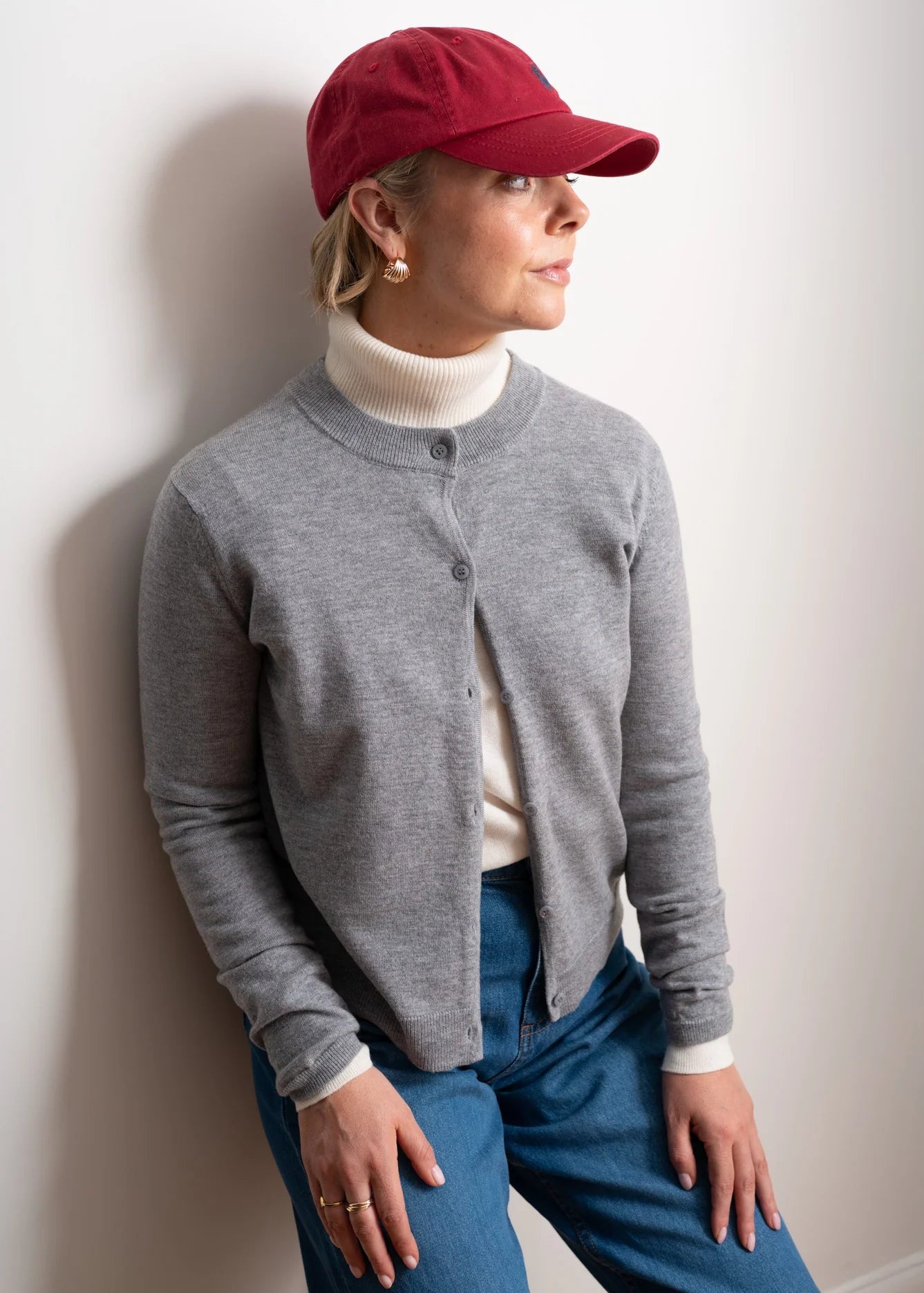 Woman wearing a grey cardigan on a white background