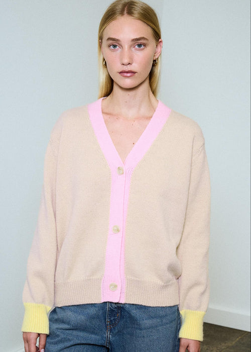 Woman wearing multi colour cardigan on blue background