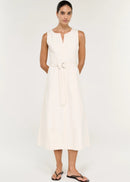 A woman modelling a sleeveless white dress with a keyhole neckline and a matching waist tie belt, photographed against a plain light background.