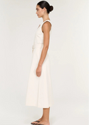 A woman modelling a sleeveless white dress with a keyhole neckline and a matching waist tie belt, photographed against a plain light background.