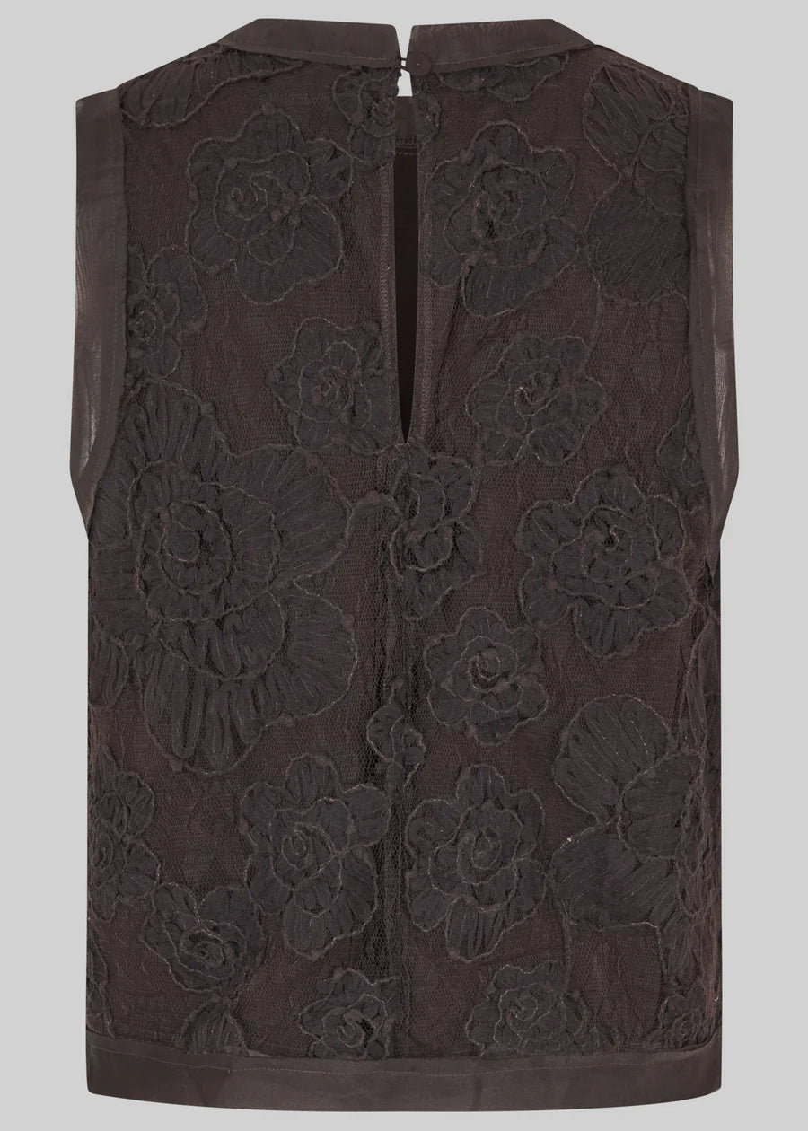 A sleeveless dark brown vest featuring a large-scale floral lace overlay and a central zipper closure, shown against a solid grey background.