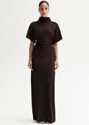 Woman wearing a brown dress with a white background