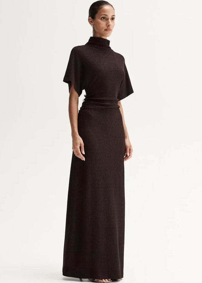 Woman wearing a brown dress with a white background