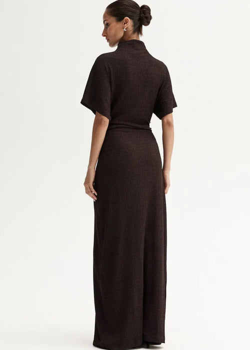 Woman wearing a brown dress with a white background