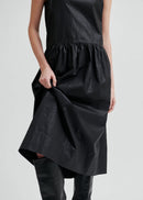 Woman wearing a black sleeveless dress on a white background
