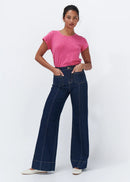 Woman wearing dark blue jeans on a white background