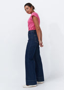 Woman wearing dark blue jeans on a white background