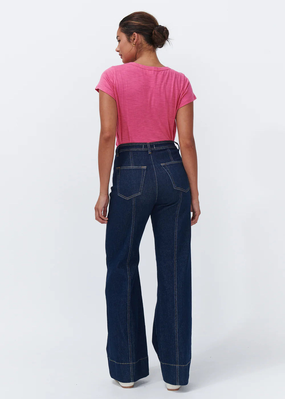 Woman wearing dark blue jeans on a white background