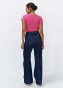 Woman wearing dark blue jeans on a white background