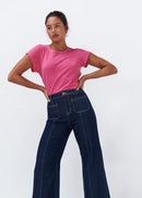 Woman wearing dark blue jeans on a white background