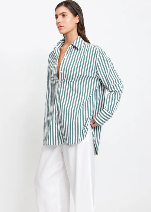 Woman wearing a green and white striped shirt on a white background