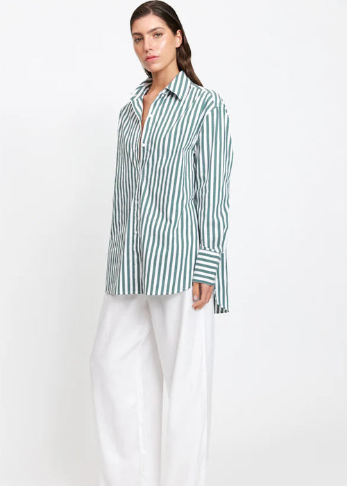 Woman wearing a green and white striped shirt on a white background