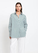 Woman wearing a green and white striped shirt on a white background