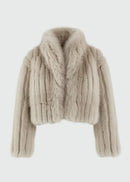 Beige faux fur jacket on a light grey background