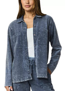 Woman wearing a blue denim shirt on a white background