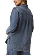 Woman wearing a blue denim shirt on a white background