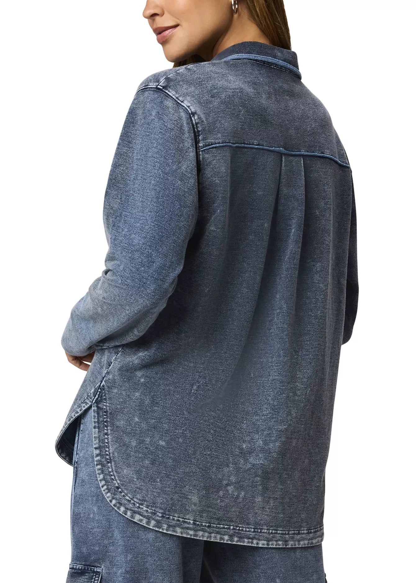 Woman wearing a blue denim shirt on a white background