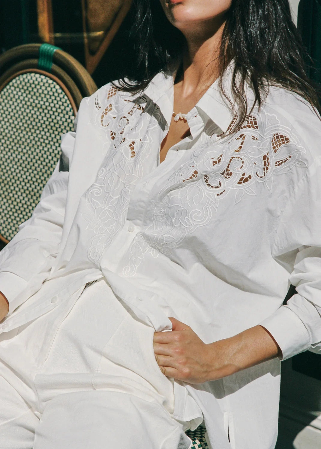Woman wearing white shirt in bright sunshine