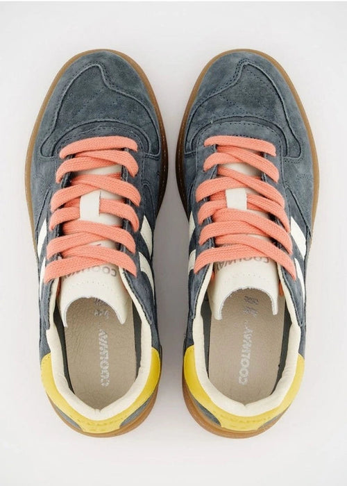 A pair of low-top sneakers shown from a top-down view on a light grey background. The shoes feature a slate blue suede upper, coral pink laces, white side stripes, a yellow heel tab, and a brown gum sole.