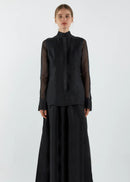 Person wearing a black outfit on a white background