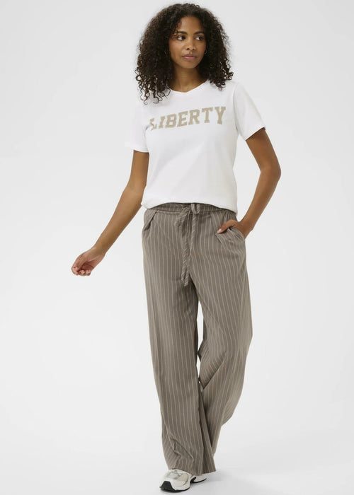 Woman wearing a white t-shirt with  a plain background