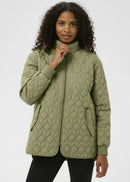 Woman wearing a quilter jacket on a white background