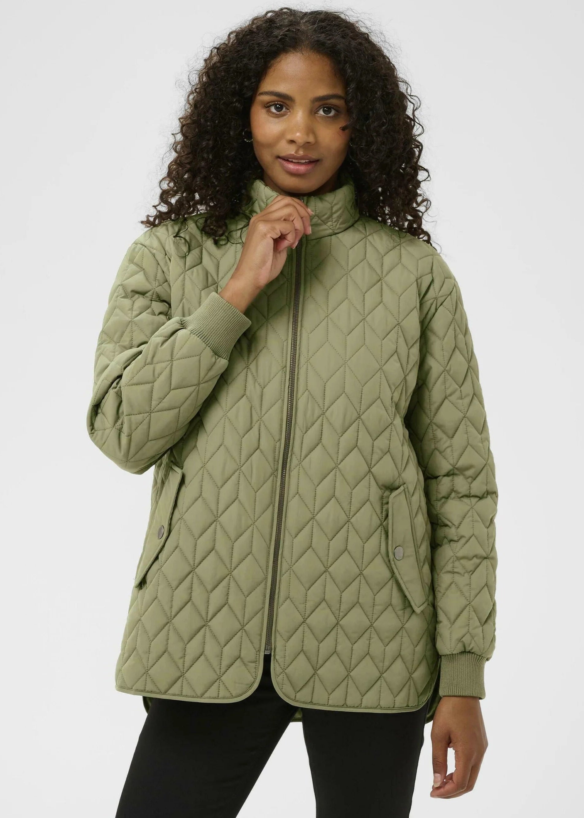 Woman wearing a quilter jacket on a white background