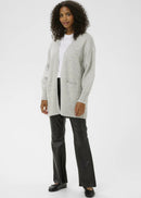 Woman wearing a light grey cardigan over a white shirt on a white background