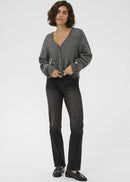 Woman wearing a grey cardigan on a plain background