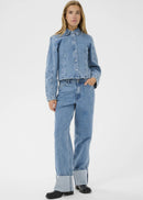 Woman wearing light blue jeans with a white background