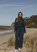 Woman wearing navy pants on the beach