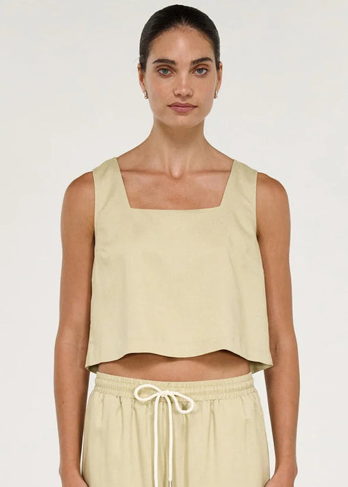 Women wearing short sleeveless beige top on white background