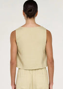 Women wearing short sleeveless beige top on white background