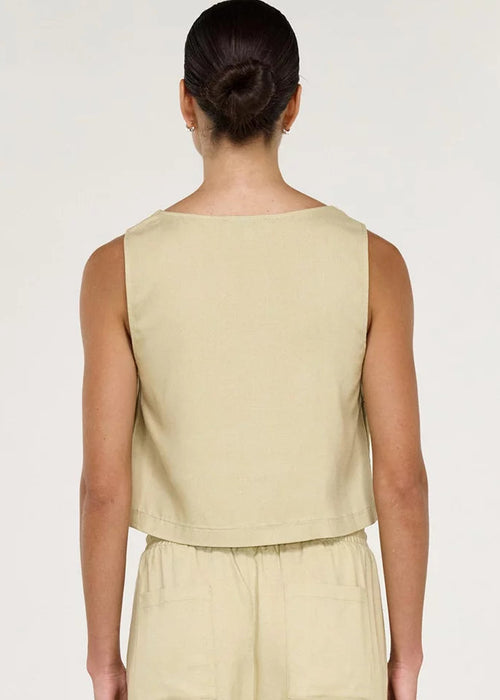 Women wearing short sleeveless beige top on white background