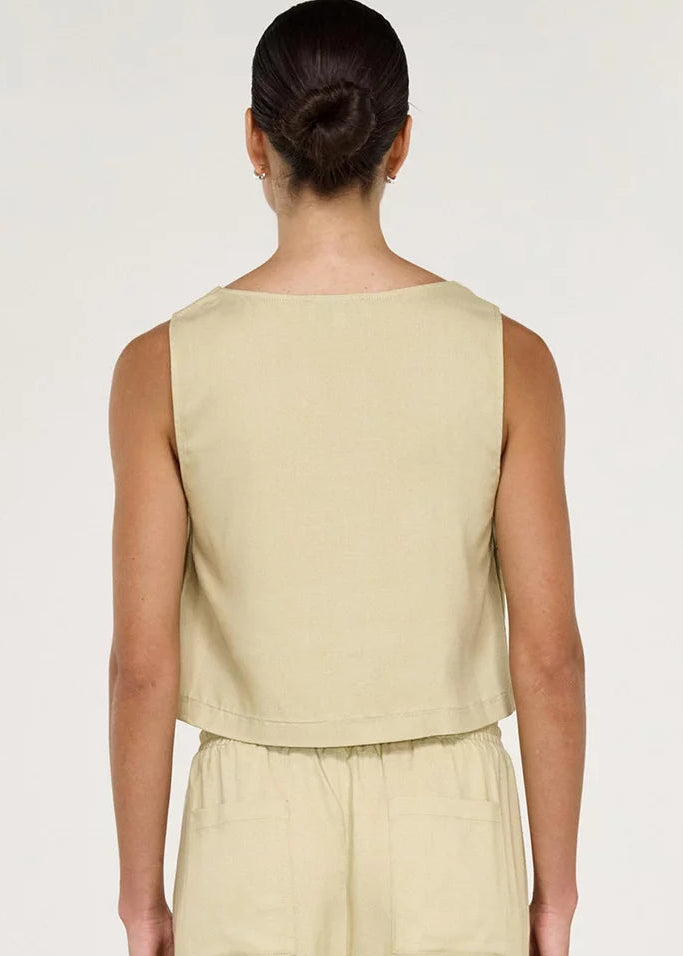 Women wearing short sleeveless beige top on white background