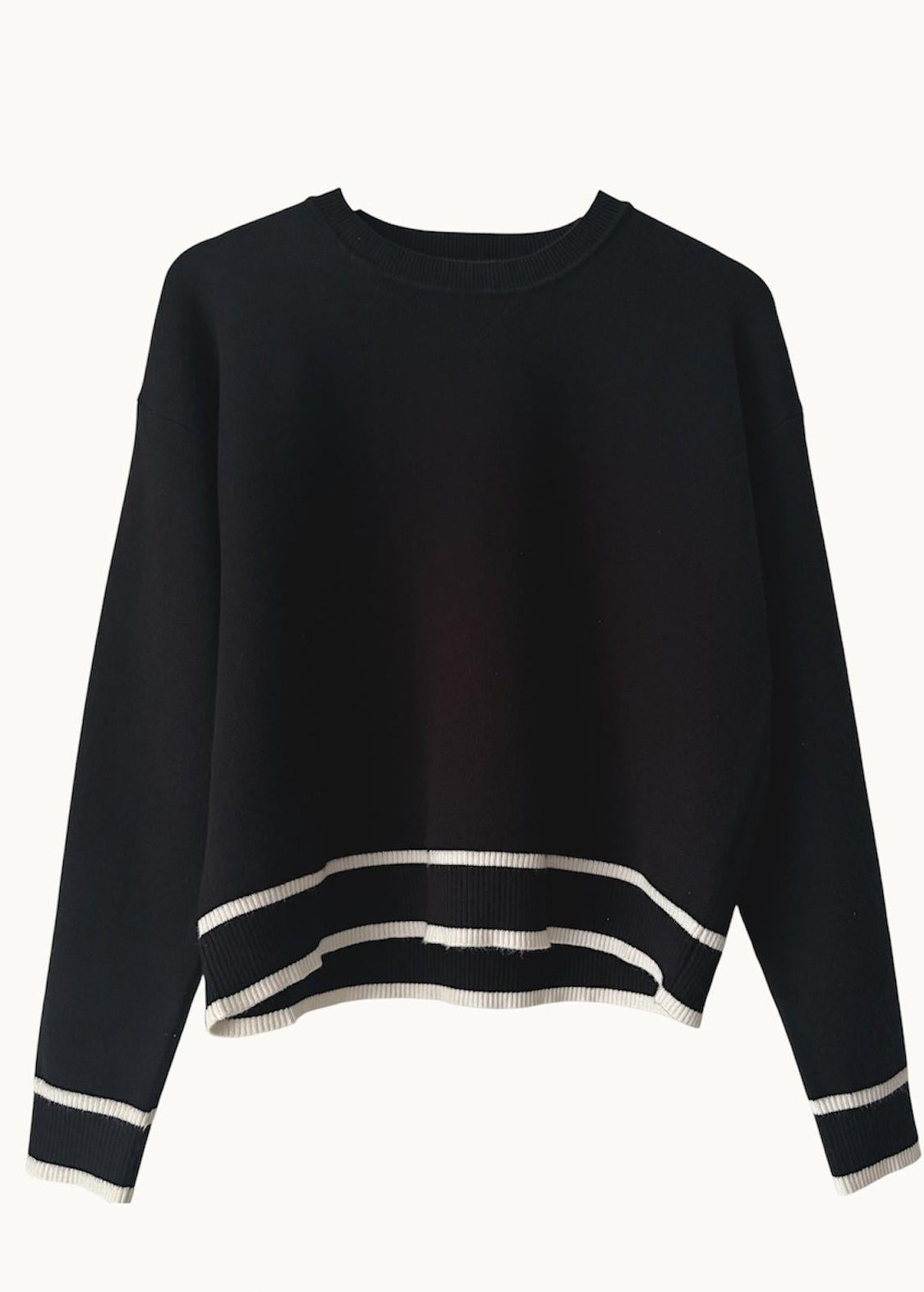 Black and with white stripe sweater on blue background