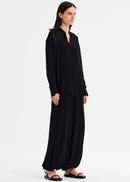 Woman wearing a black outfit on a white background