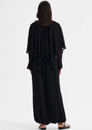 Woman wearing a black outfit on a white background