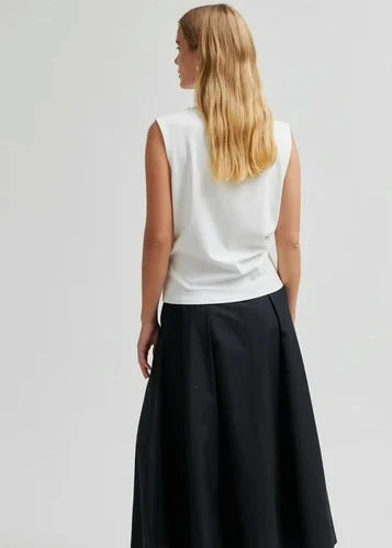 Woman modelling white tee on grey background