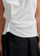 Woman modelling white tee on grey background