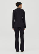 Person wearing a black suit on a white background