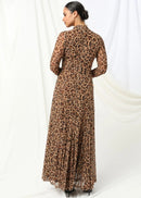 Woman wearing a leopard print dress against a white background