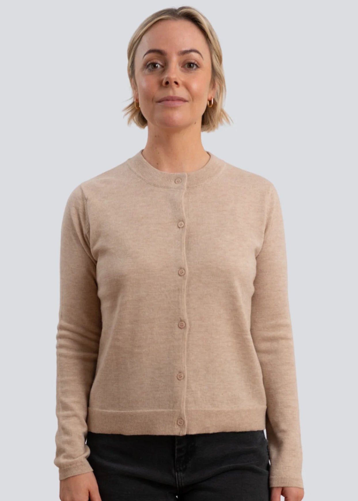 Woman wearing brown cardigan on white background